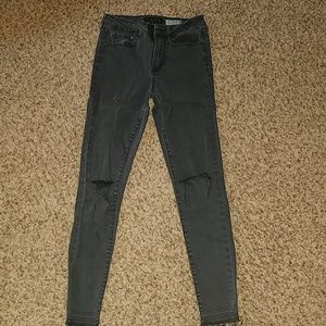 Black jeans with a slit in the knees